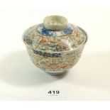 A 19th century Chinese porcelain rice bowl and lid with floral decoration, six character mark to