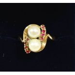 A 9 carat gold ring set two seed pearls and small rubies, size M to N