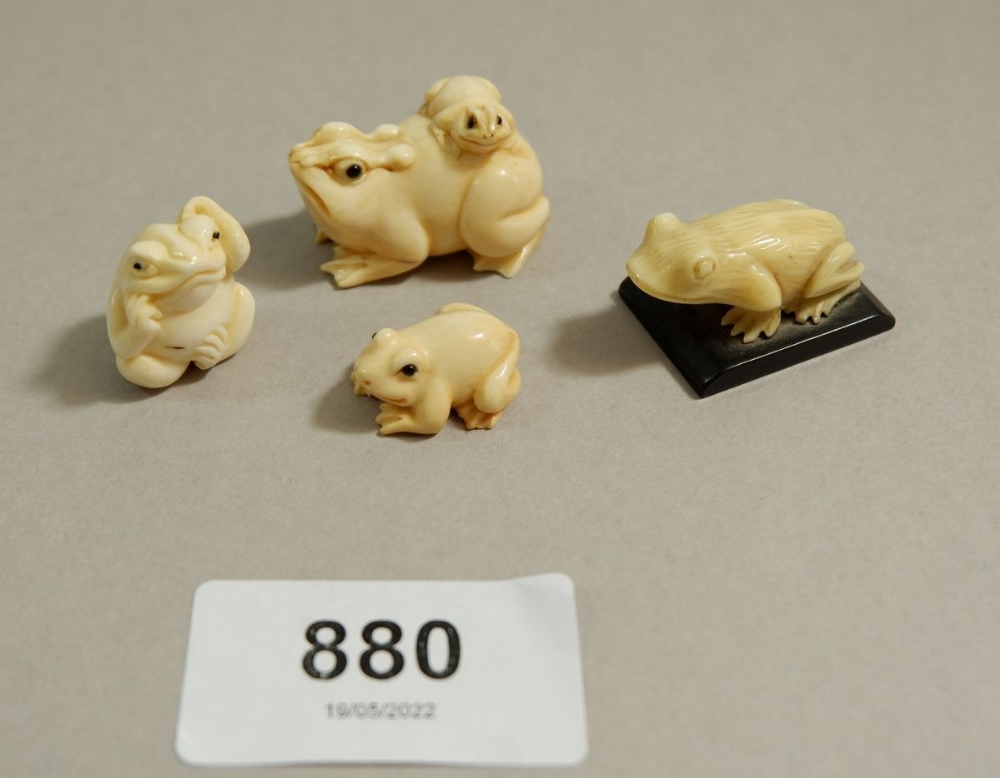 Two Japanese Meiji period ivory netsuke of frogs and two miniature carved frogs - the netsuke
