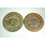 Two Indian copper and brass salvers with applied white metal decoration, largest 35cm