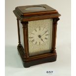A 19th century wooden mantel clock carved pillastas with engraved metal face