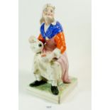 A Victorian large Staffordshire figure of woman seated with flagon, 31cm tall