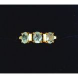 A 9 carat gold ring set three aquamarines, size J, 2.4g