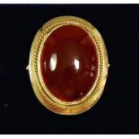 A 14 carat gold ring set orange stone, size T to U