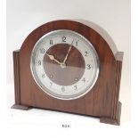 A vintage walnut striking mantel clock