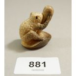 A Japanese Meiji period vegetable ivory netsuke of a speckled toad grasping a toadstool, signed, 4cm