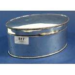 An oval silver plated biscuit box