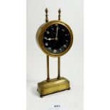 A brass self winding mantel clock