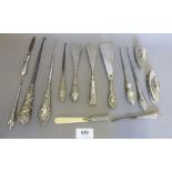 A quantity of silver handled button hooks, shoe horns etc.