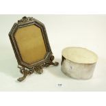 An electroplated cast metal photograph frame and a silver plated biscuit box