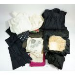 A box of antique and vintage textiles including Victorian black silk skirt and blouse, white full