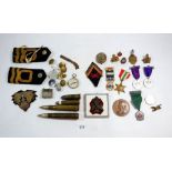 Two boxes of medals, military badges and Naval rank markings by Gieves of London