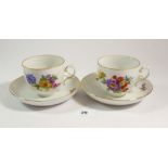 A floral painted set of seven tea cups and saucers