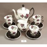 A Royal Albert Masquerade coffee set comprising: coffee pot, six cups and saucers, sugar and milk