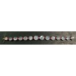 A silver gilt moonstone and ruby link bracelet, 17.5cm