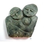 A large Inuit carved stone group, embracing couple, 34cm
