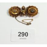 A Victorian gold brooch with applied decoration and set old cut diamonds, repaired, 7.6g