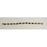 A 9 carat gold bracelet set green stones, 9.5g