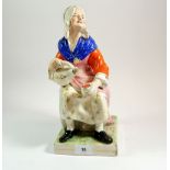 A Victorian large Staffordshire figure of woman seated with flagon, 31cm tall