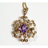 An Edwardian 9 carat gold amethyst and seed pearl pendant/brooch on 9 carat gold chain in original