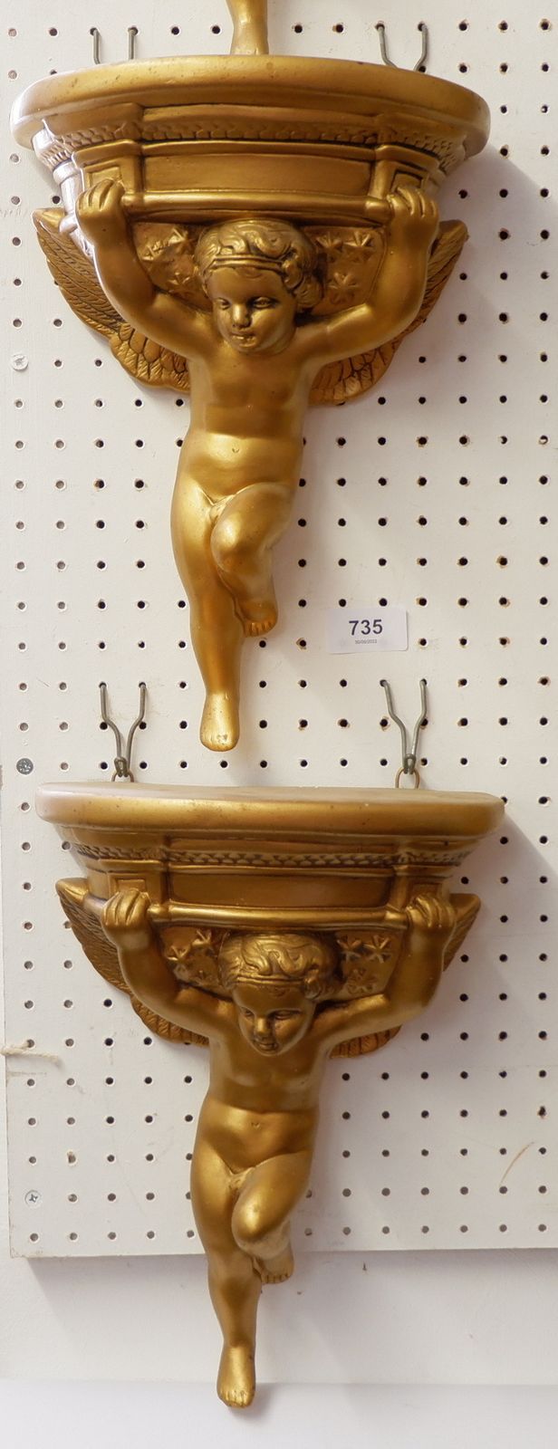 A pair of gilt plaster cherub wall brackets, 31 cm