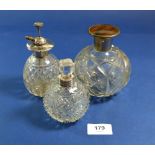 A silver plated and cut glass atomiser and two scent bottles