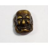 A Japanese bronze finish miniature mask, 3.5 x 3cm