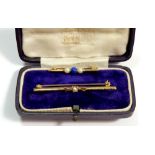 A 9 carat gold bar brooch set pearl, boxed and a yellow metal bar brooch set blue stone and pearl