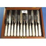 A boxed set of twelve pairs of silver fruit knives and forks with mother of pearl handles, Sheffield
