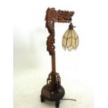 A Chinese dragon form carved table lamp with pendant hanging shade 72cm tall
