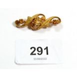 A 9 carat gold scrollwork brooch set three citrines, 3.8cm, 5g