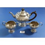 A silver three piece tea service with gadrooned border and pedestal foot, Sheffield 1898 Jenkins &
