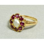 An 18 carat gold ruby and pearl cluster ring 12 x 11mm, size Q to R, 4g