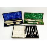 A silver plated nutcraker set and two pairs of Victorian silver plated fish servers (one with silver