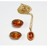 A 9 carat gold and amber pendant and similar pair of earrings