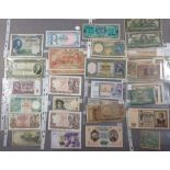 A wad of world banknotes with examples countries including: Austria, Canada, France, Greece,