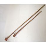 Two copper coaching horns, one 84cm the other 122cm