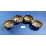 Two pairs of Indian white metal dishes with embossed decoration, 11cm diameter