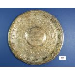 A Ceylonese white metal salver with embossed decoration, with inscription dated 1966, 397g