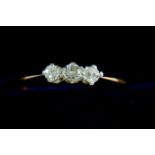 An 18ct gold and platinum three stone diamond ring, size O