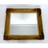 A 19th century carved and gilt mirror with shell and foliate corners, 87 x 98 cm