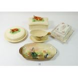 Two butter dishes with cow finials, a Doulton Series ware dish, Royal Winton sauce boat and a floral