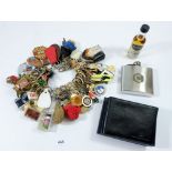 A collection of keyrings, a pewter hip flask and leather wallet