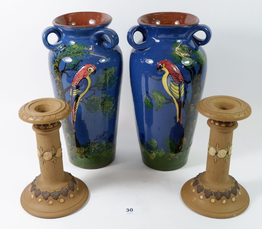 A pair of Torquay Ware vases, 25cm painted parrots and a pair of Doulton Silicon Ware candlesticks