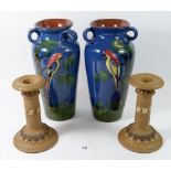 A pair of Torquay Ware vases, 25cm painted parrots and a pair of Doulton Silicon Ware candlesticks