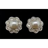 A fine pair of diamond and pearl cluster earrings, 1.2cm diameter