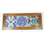 Three Iznik (Ottoman?) tiles in an oak frame