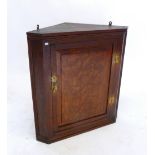 An oak small corner cupboard with panelled door, 64 x 59 cm