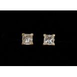 An 18 carat gold pair of square cut diamond earrings