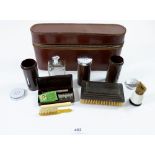 An early 20th century ebony and Bakelite gentleman's toiletry set in fitted leather case
